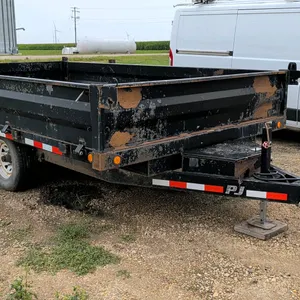 PJ Trailers dump trailer. Features 19"H sidewalls, hold-down sides, and a rear gate that swings up or double-splits swing-out. Equipped with twin axle