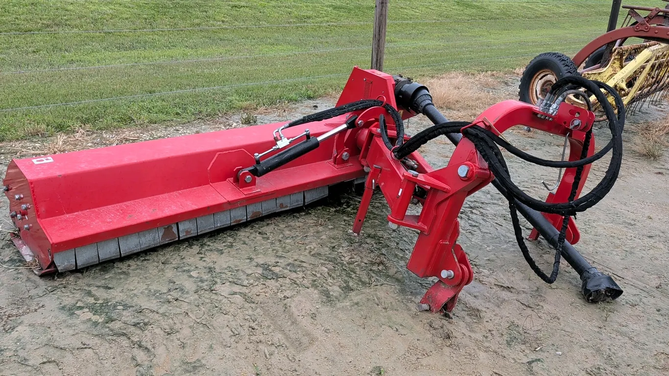Titan 3-point mount flail mower. Features hydraulic offset and tilt adjustments, integrated PTO drive shaft, and front safety flaps. 7'L.