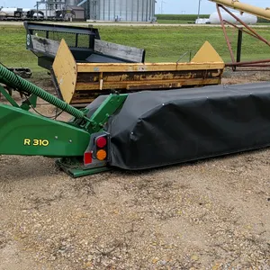 John Deere R310 disc mower. Features a rear 3-point hitch connection, PTO drive shaft, and hydraulic lift folding mechanism. Equipped with a protectiv