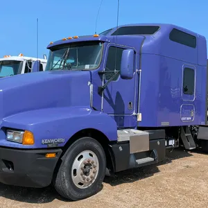 2006 Kenworth semi-tractor with studio sleeper. Features a purple finish, tandem axles, sliding fifth wheel, rear exhaust stack, and dual fuel tanks. 