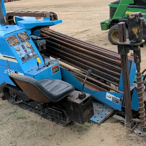 1999 Ditch Witch JT520 horizontal directional drill. Features loaded drill pipe rack, operator station with controls, and hydraulic anchoring system. 