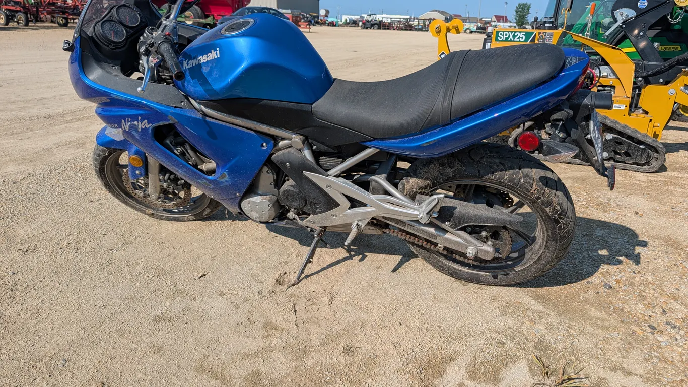 2007 Kawasaki Ninja 650R motorcycle. Features a blue finish, liquid-cooled engine, chain drive, dual front disc brakes, and a two-up seat. Instrument