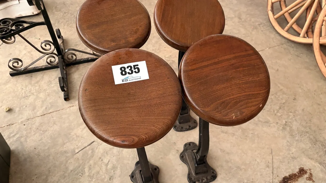 FOUR VINTAGE INDUSTRIAL FLOOR MOUNTED STOOLS