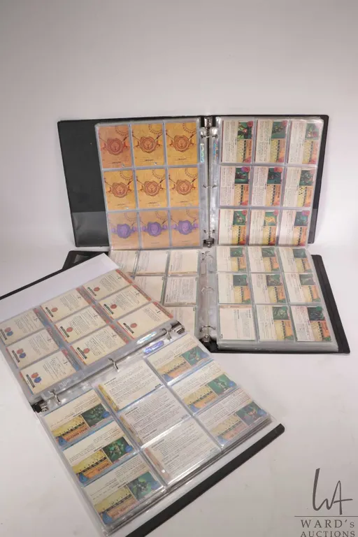 Three 3 ring binders containing a large selection of Malifaux collectible gaming cards