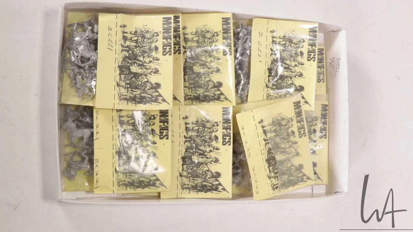 Box containing a selection of Minifigs metal models including mostly horses and some knights