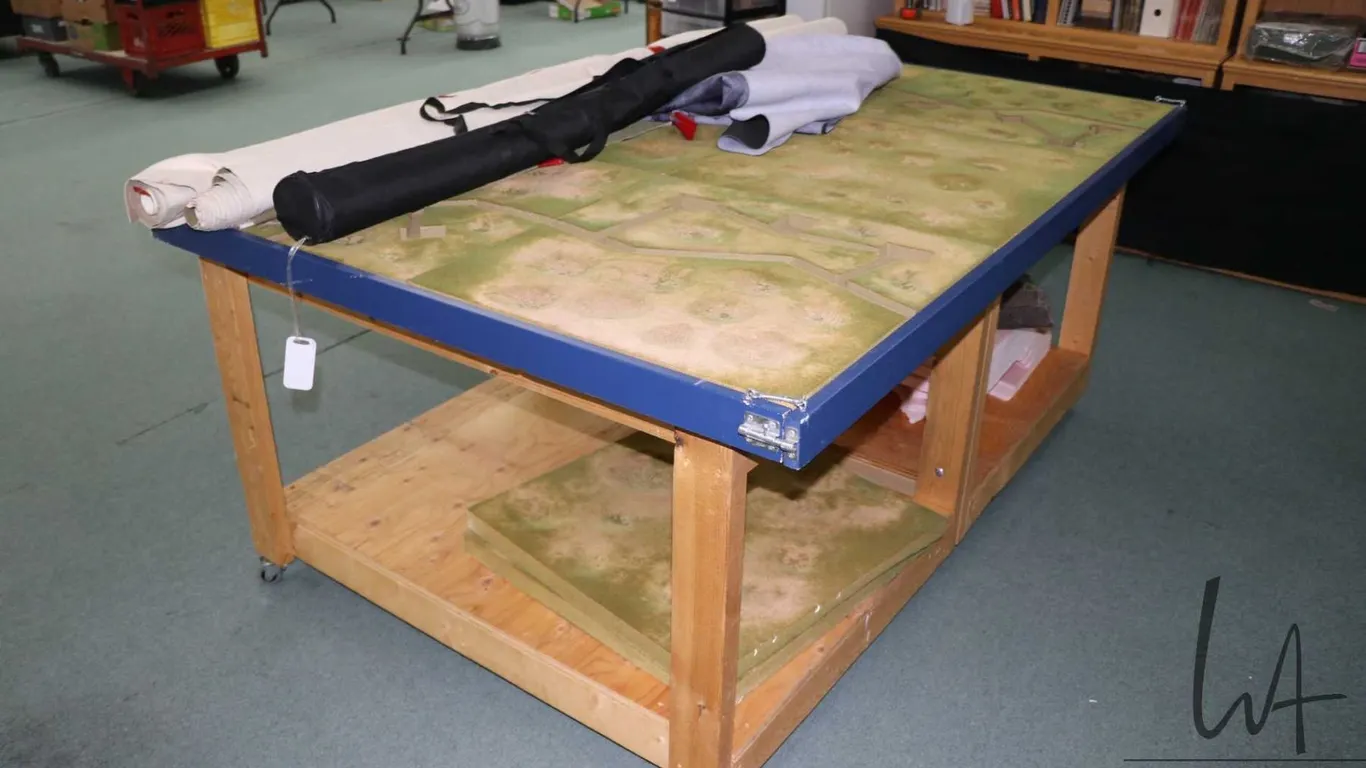 Handmade wooden wargaming table with undershelf, on castors, fitted with WWII trench terrain, 31" H