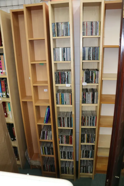 Four DVD and CD shelving units and contents of music CDs