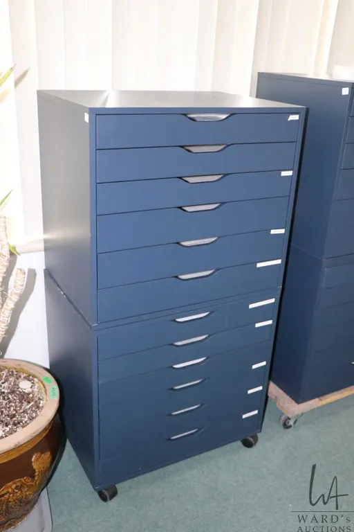 Two Ikea brand "Alex" six drawer storage cabinets, blue in colour, one with castors