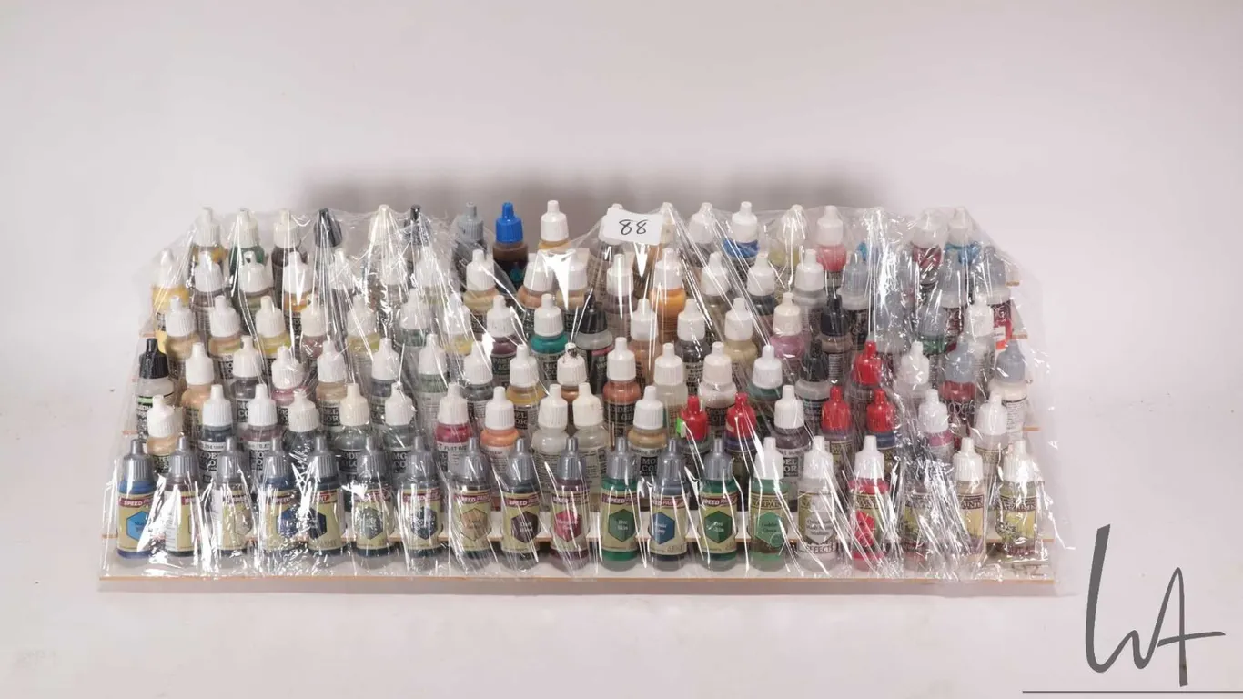 Seven tier paint holder with a large selection of dropper bottle style acrylic paints, mostly Valleg