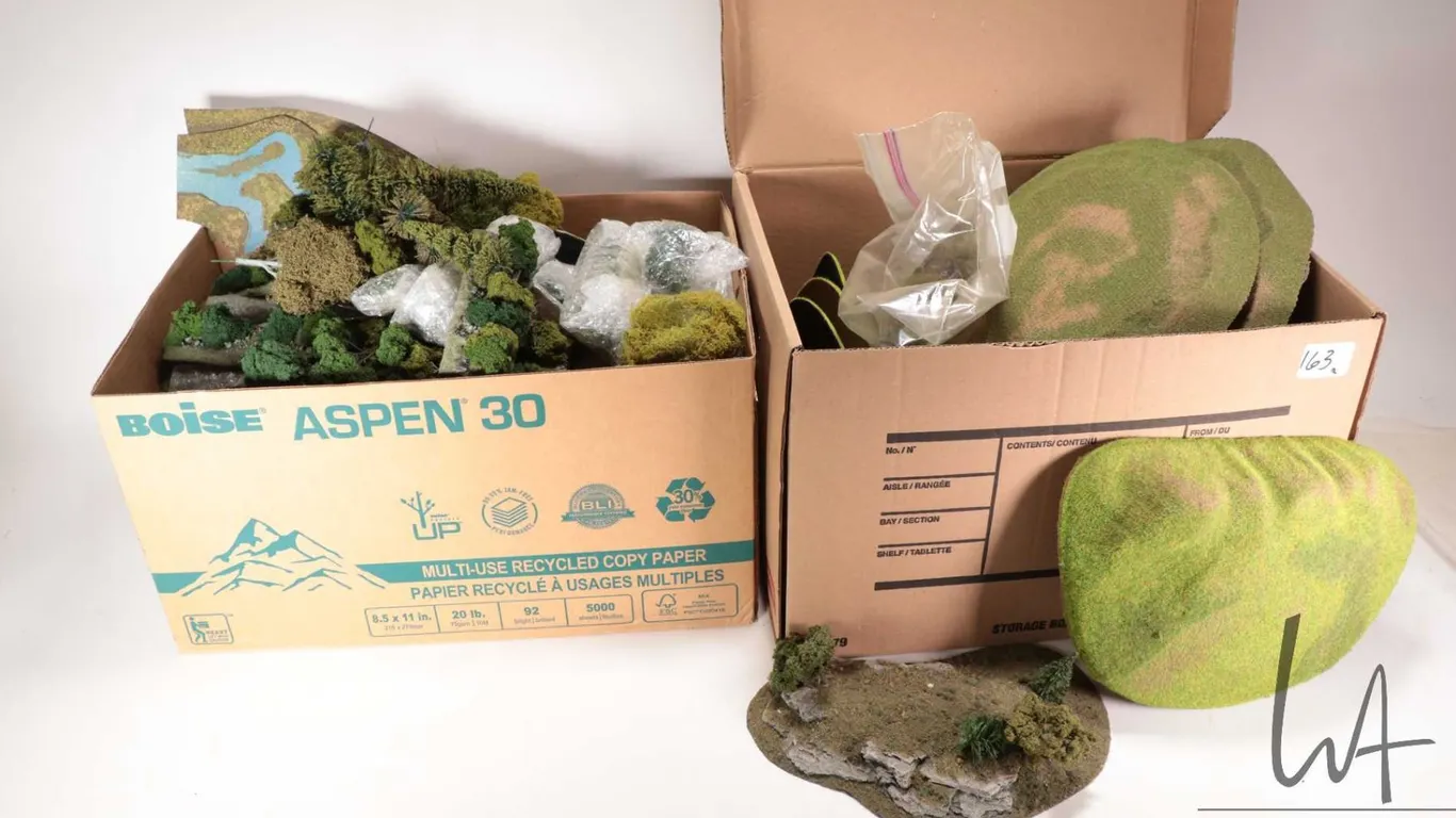 Two boxes containing a large selection of trees and terrain etc.
