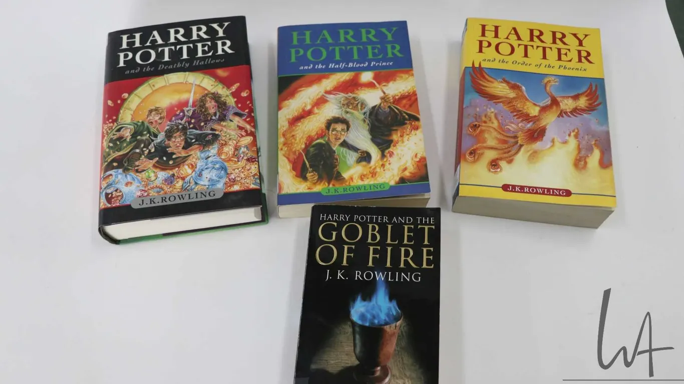 Four books from the Harry Potter series by J.K. Rowling including hardcover "Harry Potter and the De