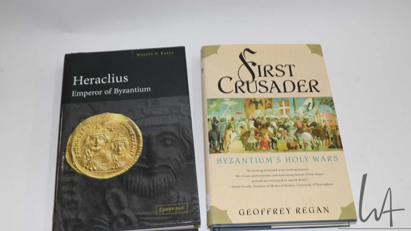 Two hardcover books including "First Crusader: Byzantium's Holy War" by Geoffrey Regan and "Heracliu