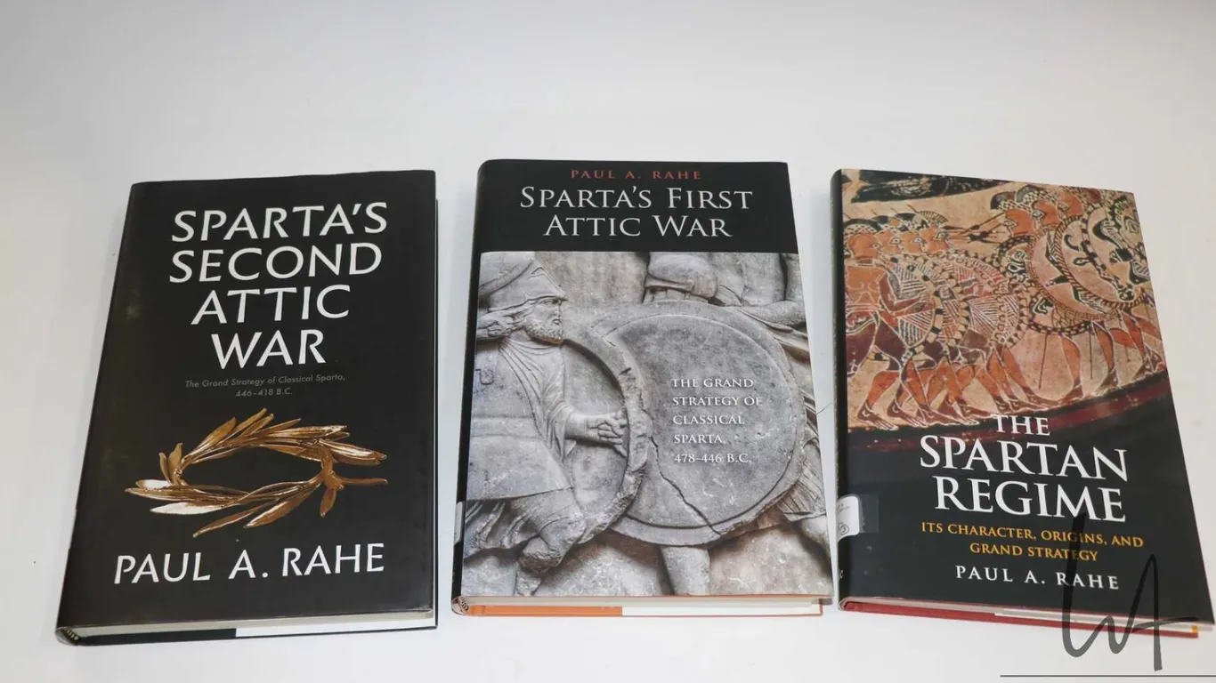 Three hardcover books including "Sparta's First Attic War", "The Spartan Regime" and Sparta's Second