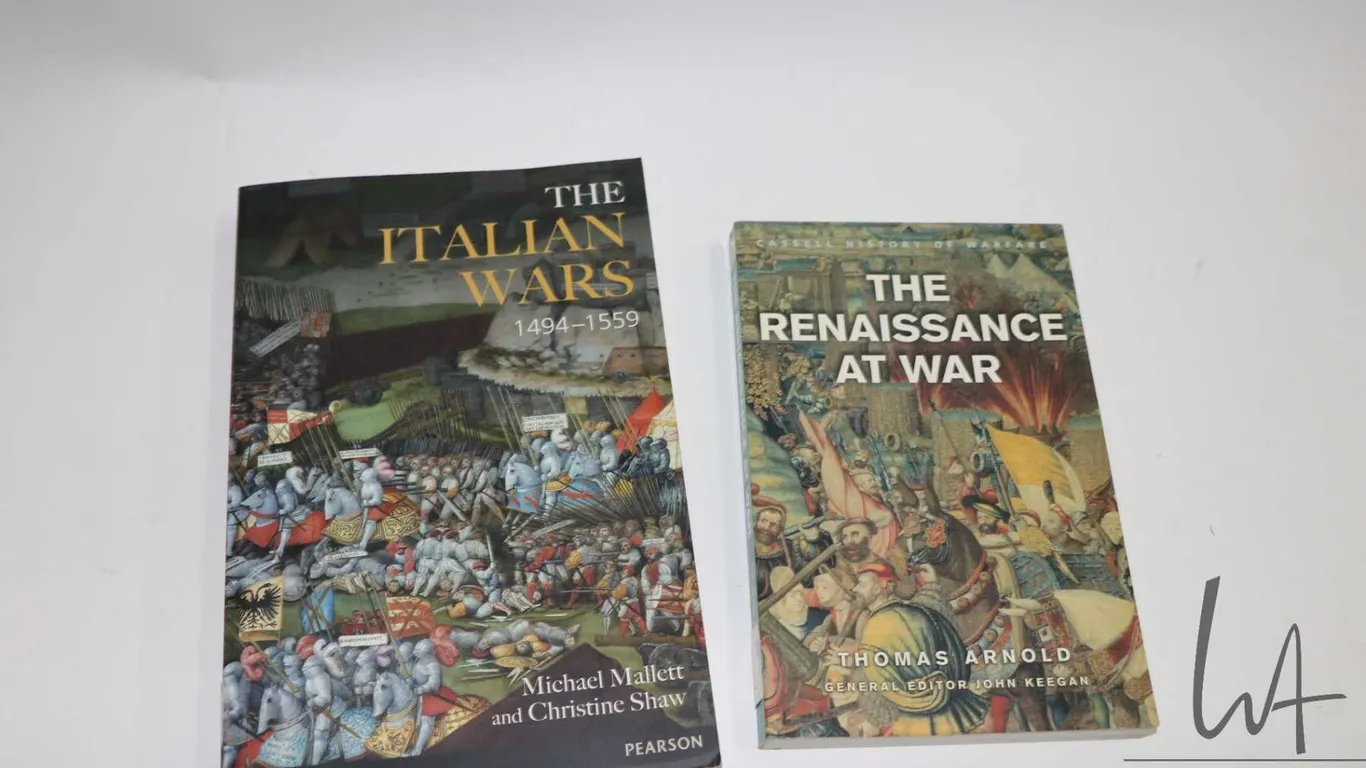 Two softcover books including "Cassell History of Warfare: The Renaissance at War" by Thomas Arnold