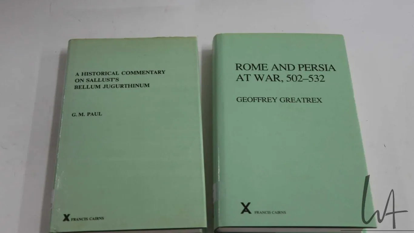 Two hardcover books including "Rome and Persia, 502-532" by Geoffrey Greatrex and "A Historical Comm