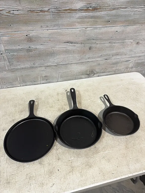 8” lodge cast iron skillet, 10” kitchenaid cast iron skillet and 10” lodge cast iron griddle