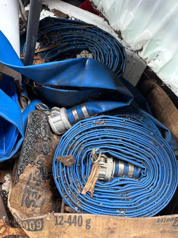 Several Blue Layflat Discharge Hoses with Coupler