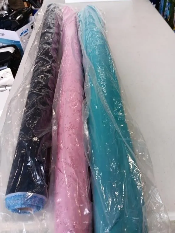 Three rolls of fabric 45in wide, unknown length,