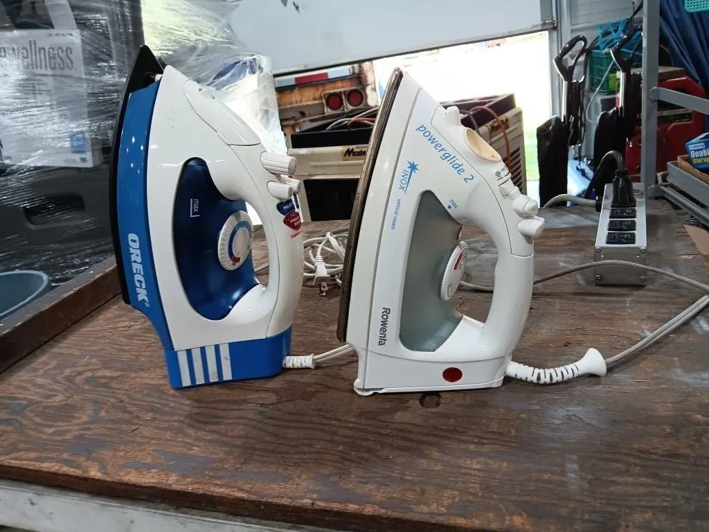 Oreck & Rowenta Steam Irons. Both Turned On And
