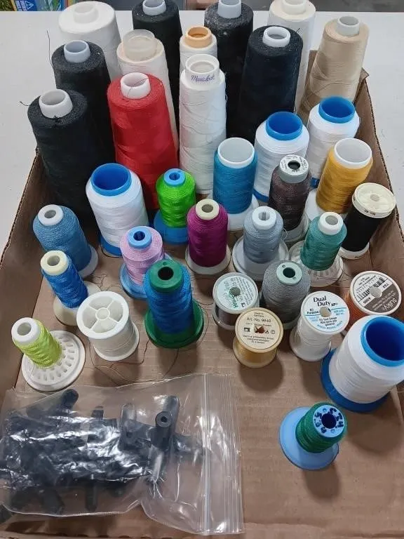 Assortment of sewing thread and spool holders.