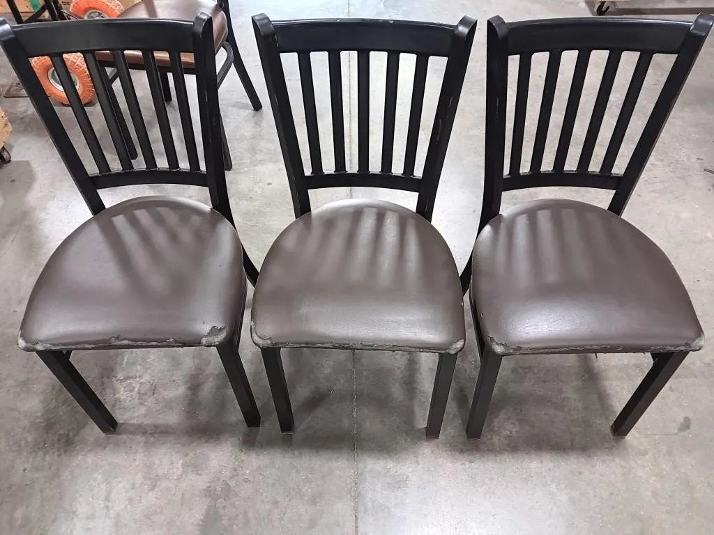 Three metal chairs and one wooden chair with