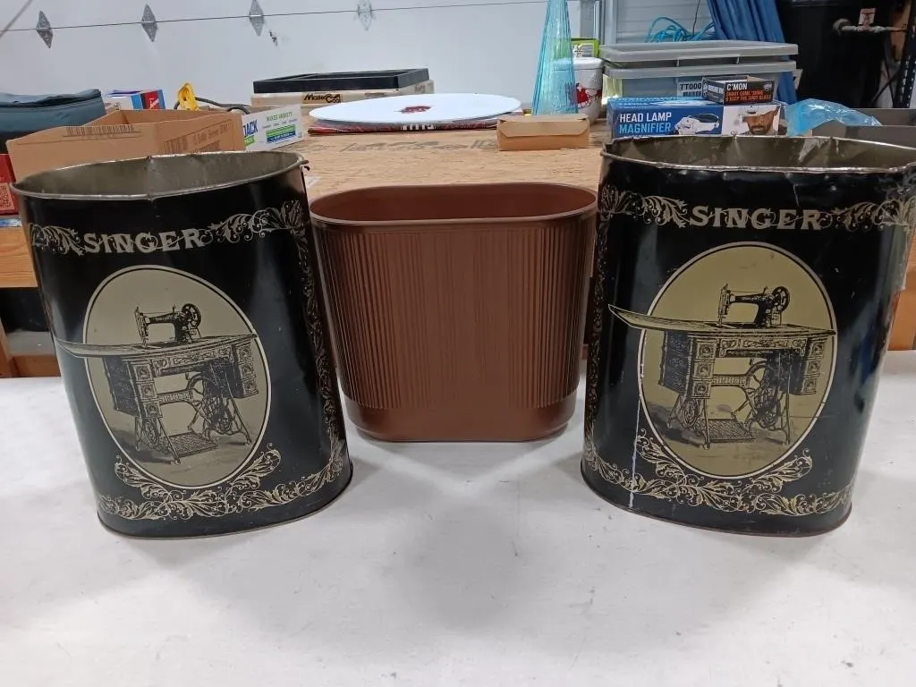 Two Singer nostalgia trash cans and small plastic