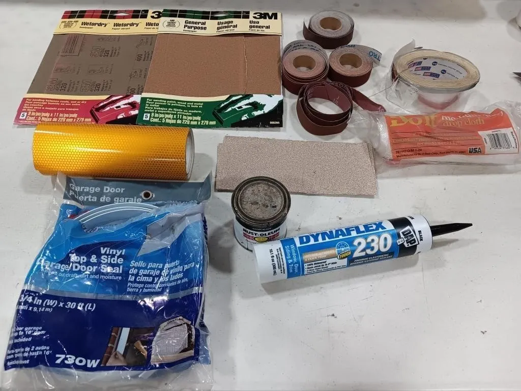Box of assorted sandpaper, sealant,paint and