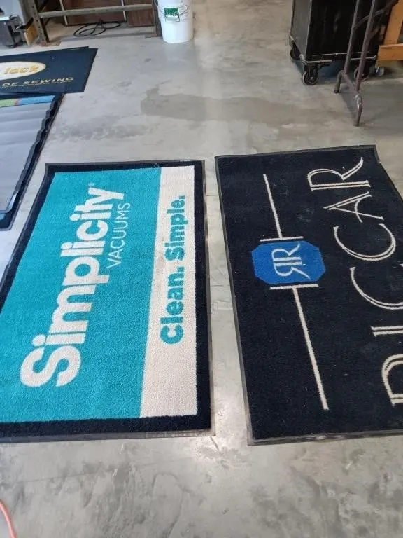 Two carpeted rubber mats approximately 58.5x33