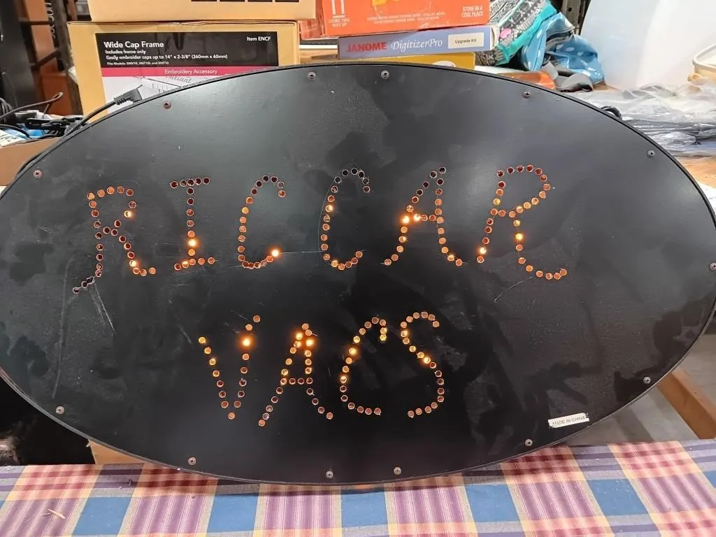 Lighted oval shaped sign approximately 27x1.5x15