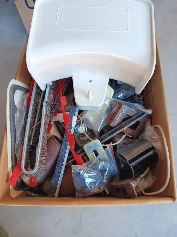 Box of vacuum parts and pieces and cord holder