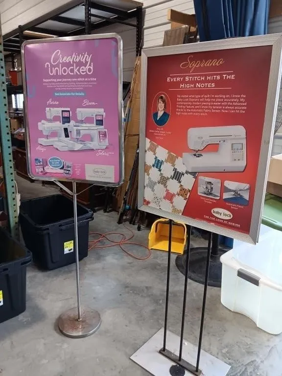 Two metal free standing advertising signs,