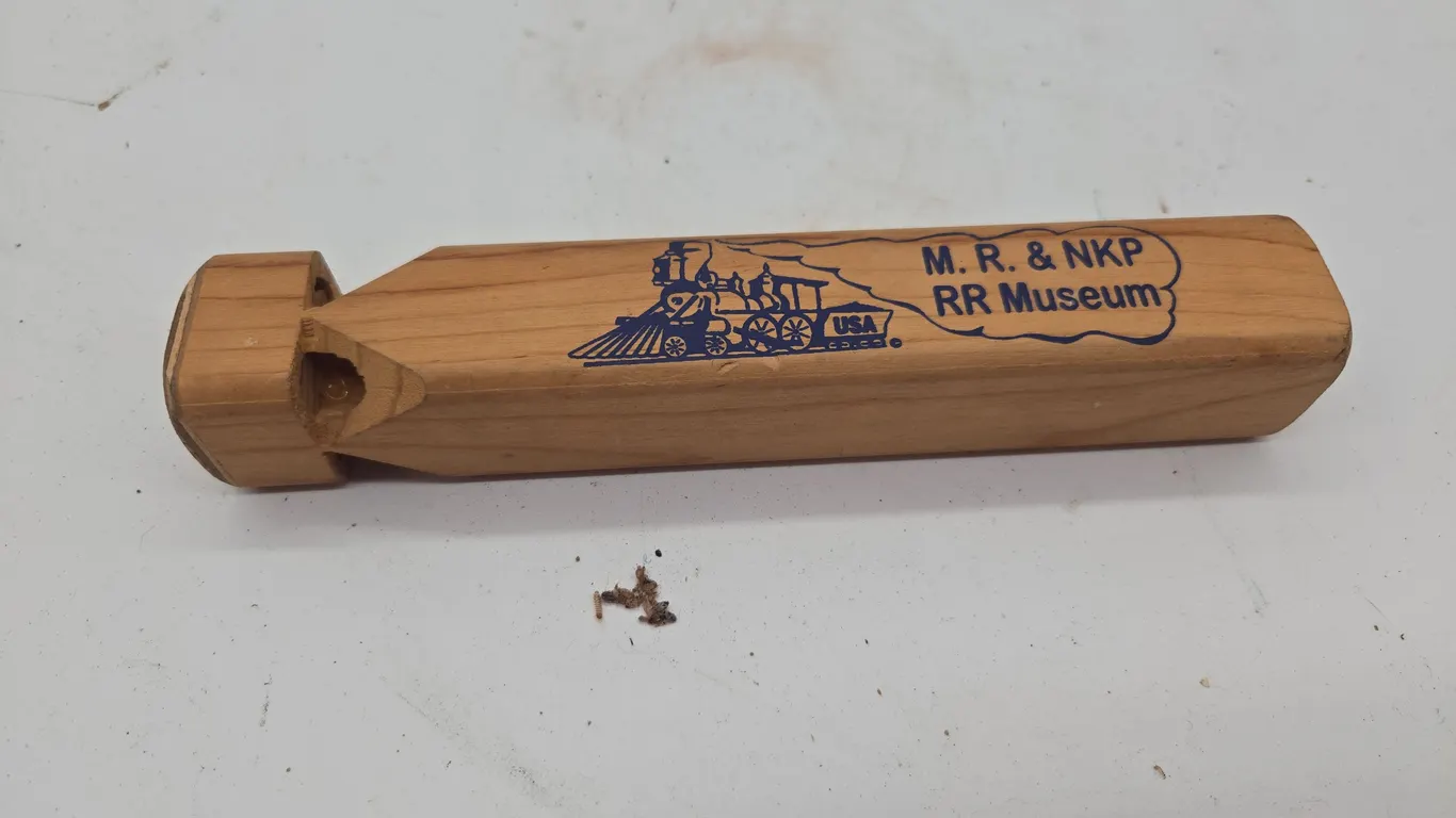 The vintage wooden train whistle.