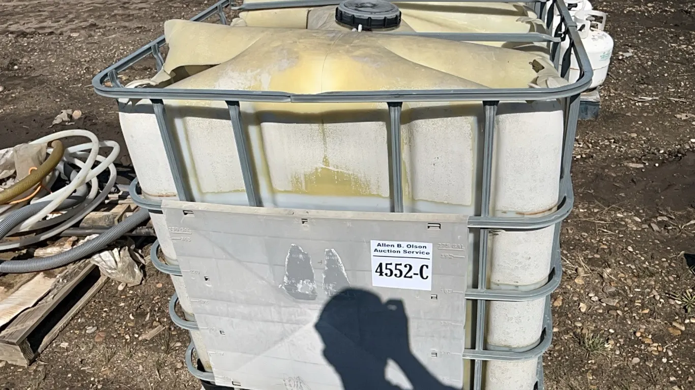PLASTIC TOTE IN A METAL CAGE