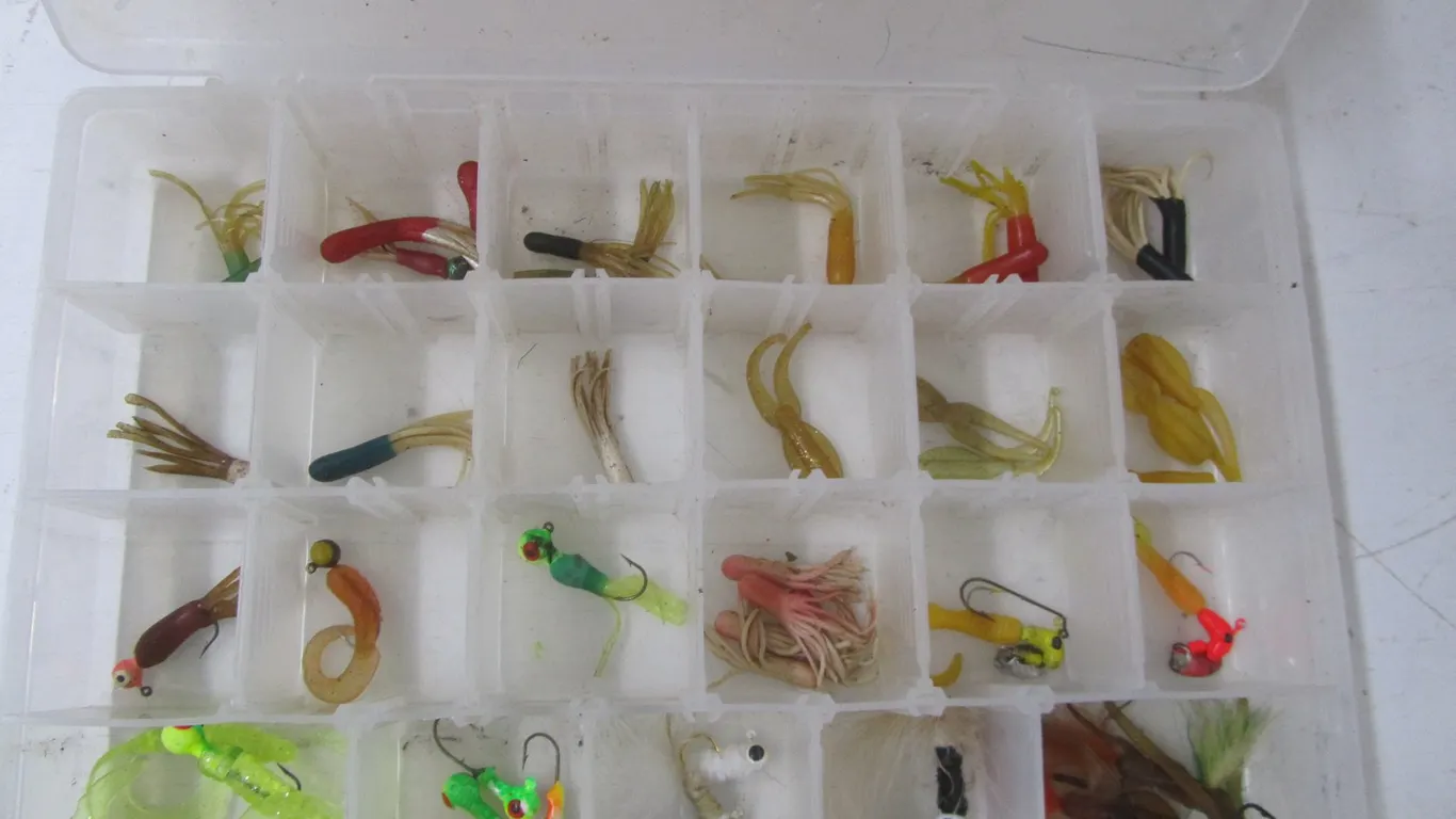 Plano Tackle Organizer Full Of Assorted Jigs And Plastic Baits