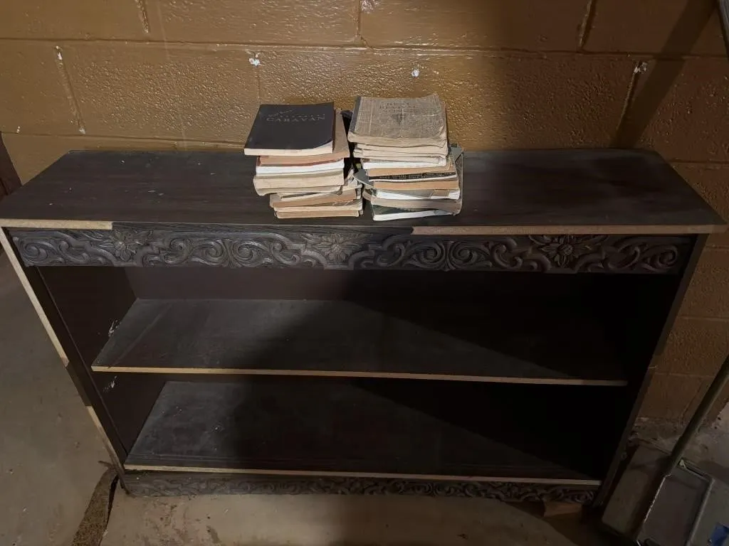Wooden shelf with some books