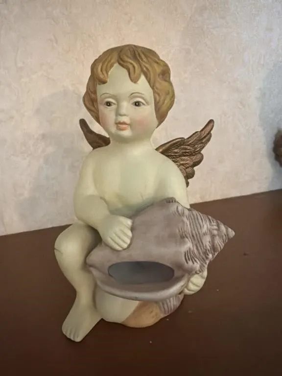 Angel holding a sea shell