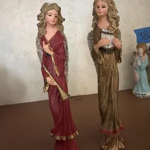 Two angels one playing trumpet and one playing a
