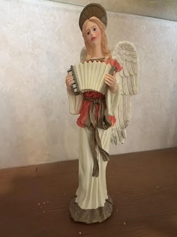 Angel holding a accordion
