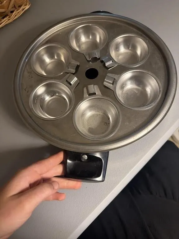 This vintage, 6-cup stainless steel egg poacher