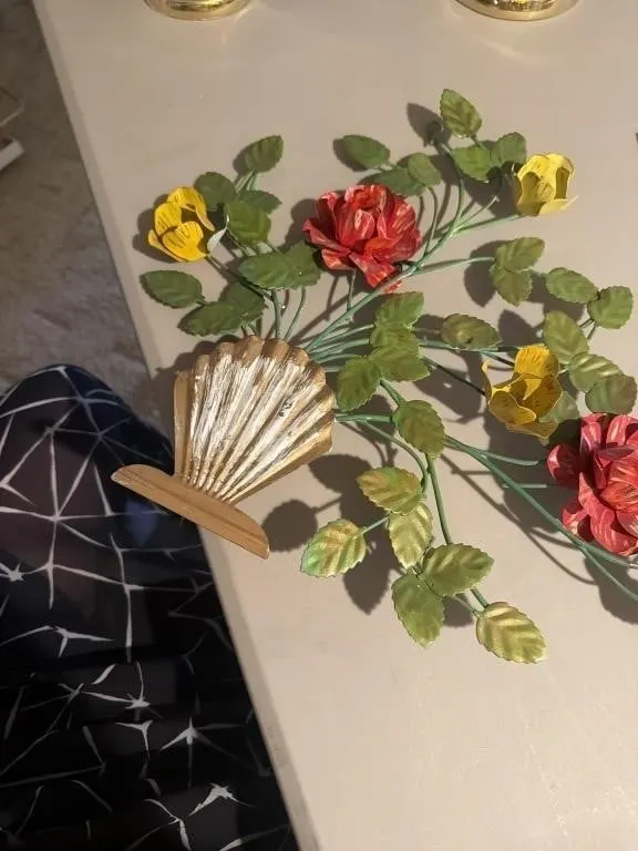 This vintage-style metal tole wall art features