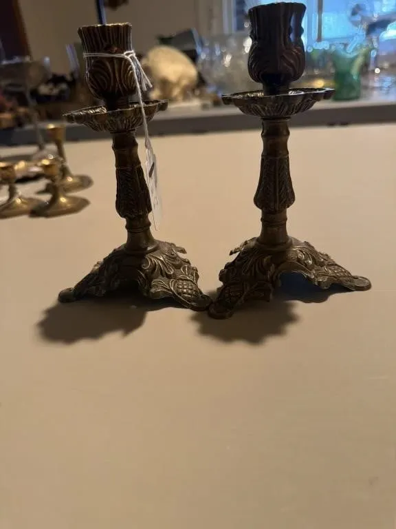These ornate brass candle holders appear similar