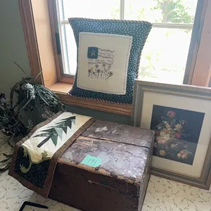 wooden chest, pillow, wreath, wall hanging