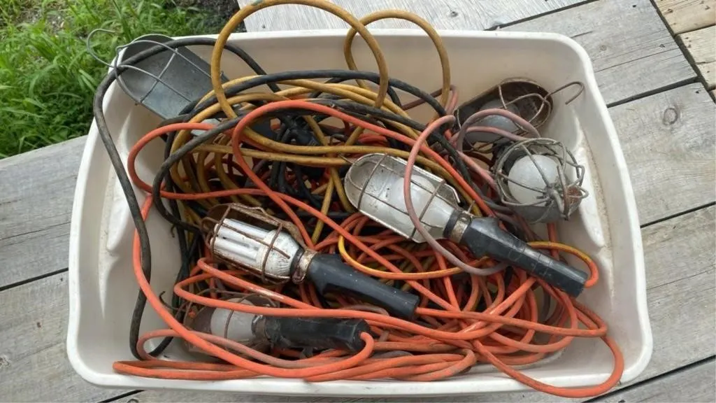 Bin of work lights and extension cords