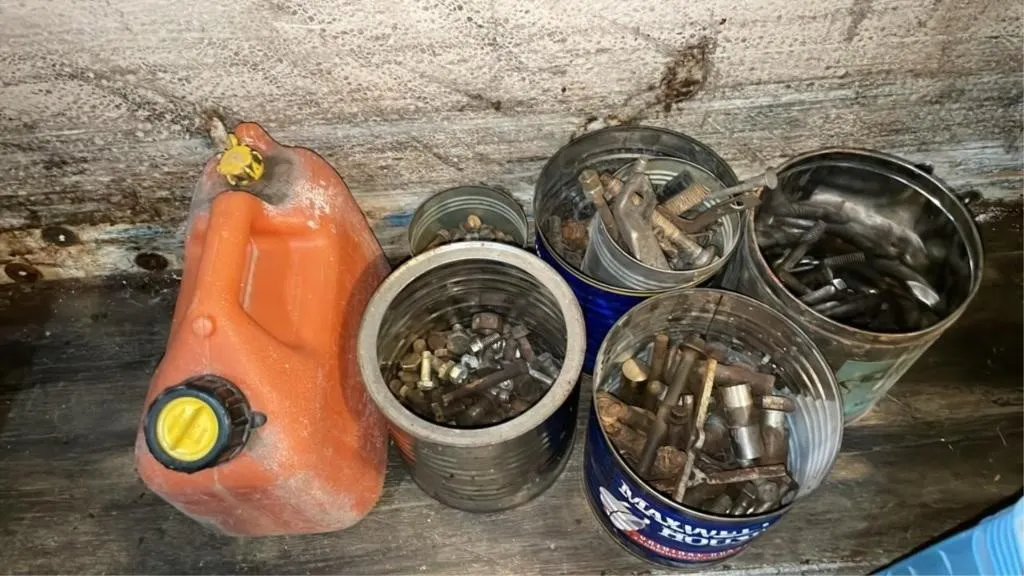 Assorted bolts, washers and small gas can