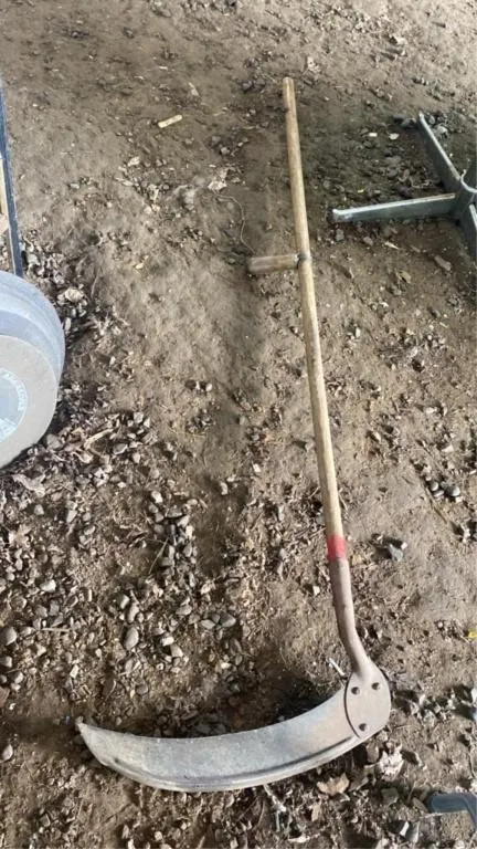 Scythe with wooden handle