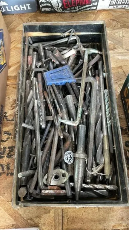 Small bin of Allen keys and drill bits