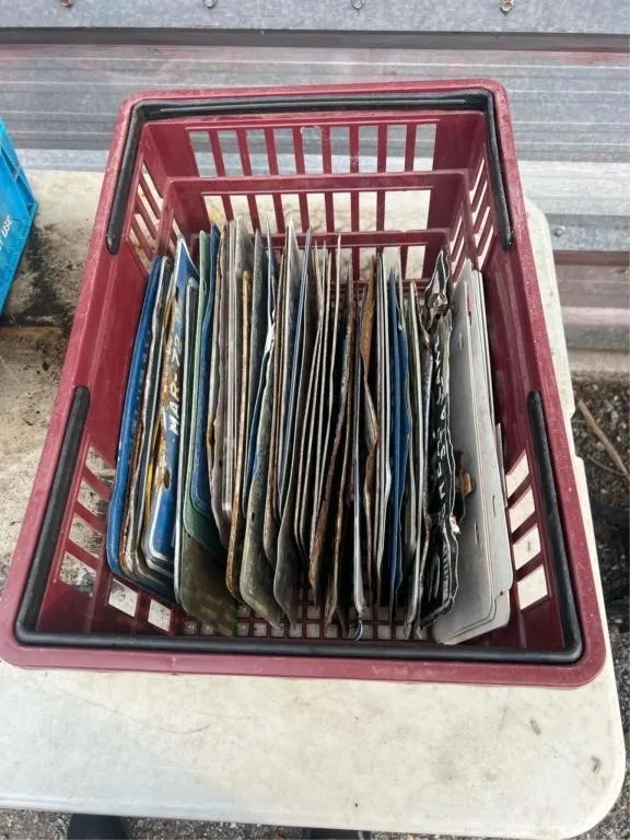 Basket of vintage license plates