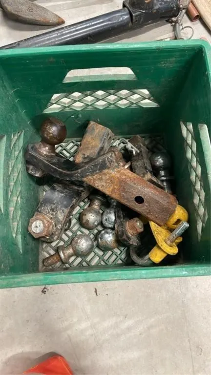 Crate of trailer hitches and hitch balls