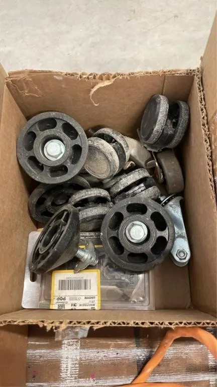 Box of various plastic wheels and more