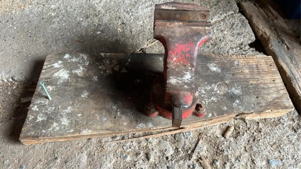 Small vise bolted to wood
